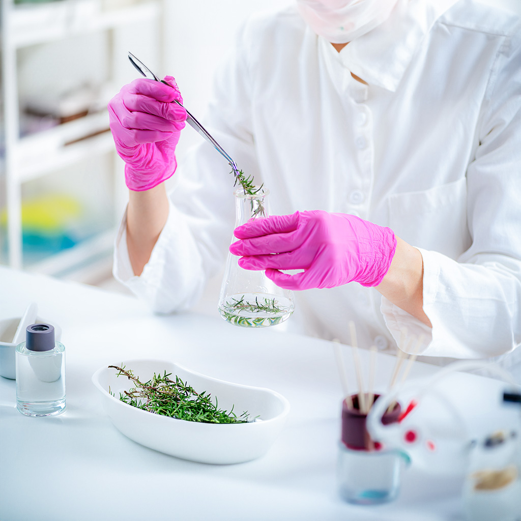 aromacology expert preparing flask with fragrance ingredients 1