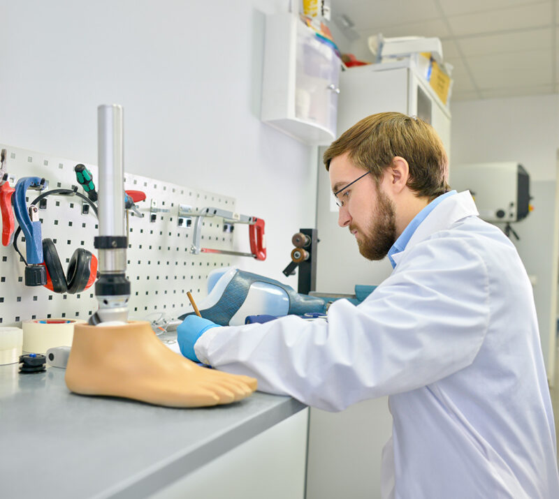 young prosthetist working laboratory