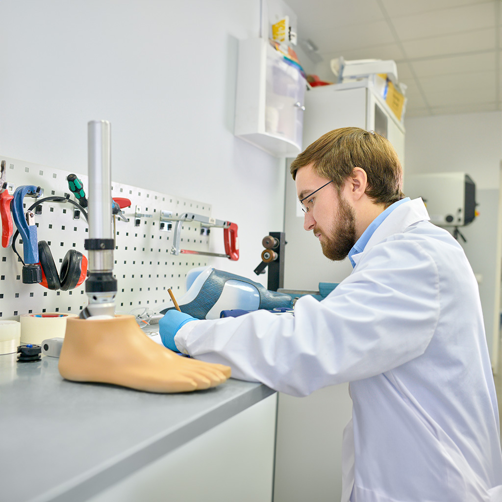 young prosthetist working laboratory